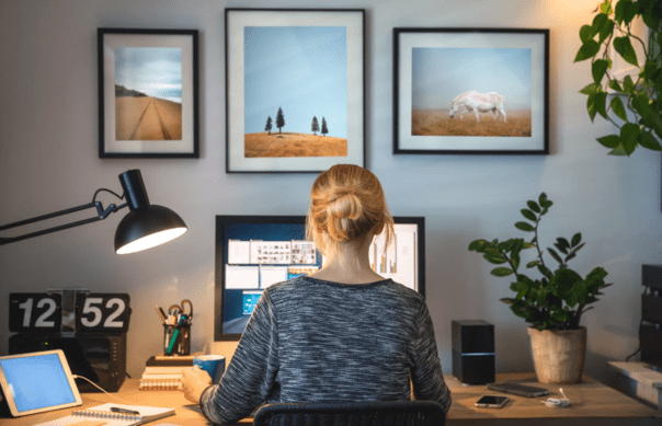 A woman working from home on her desk.